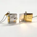 Book-shaped envelope necklace in gold and silver finish with Granddaughter engraving - Two-tone Granddaughter Centered Quote Style
