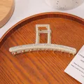Grande pince à cheveux dorée ornée de perles et strass sur un plateau en bois - Forme Droite avec Perles et Strass