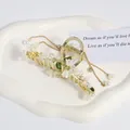 Pince à cheveux élégante muguet en métal doré avec perles et longs glands de chaîne - Gland Long de Feuille de Muguet