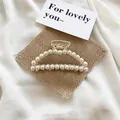 Pince à cheveux élégante en métal doré avec doubles rangées de perles blanches - Grande Perle Demi-cercle