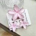 Set of 3 pale pink frangipani flower hair claws on display card with stone background - Pink Set With Transparent Snap Closure (including Card)