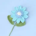 Handmade crochet light blue sunflower with green leaves on a soft blue background - Blue-snow Five Seeded Sunflower Stem (double Leaves)