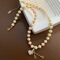 Beaded titanium steel necklace with strawberry crystal heart pendant and golden coins - Light Champagne Faceted Bead Heart Style (04-J27)