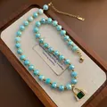 Beaded necklace with blue stones and green emerald-cut pendant on gold chain - Blue Faceted Bead Emerald Pendant Style (04-J28)