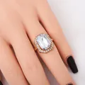 Vintage gold ring featuring a large rectangular faceted gem with a halo of small diamonds - 3003 White Ring