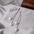Close-up of sparkling zircon stud earrings and long silver tassel pearl drop earrings - Silver Artificial Pearl Rhinestone Set
