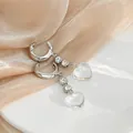 Detail shot of heart-shaped crystal pendant earrings with silver hoops and transparent beads - Silver Rhinestone Heart Pendant
