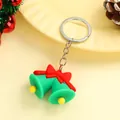 Christmas keychain featuring green bells with red bows on a festive background - Christmas Bells (silver Ring) / Approximately 3.8-5.6cm High And 2.6-3.8cm Wide.