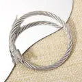 Adjustable silver cable wire bangle with crown ends and intricate woven steel texture - Crown Head Steel Cable Twisted Open Bangle (108) / Silver