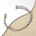Silver twisted rope open bangle with polished ball ends on woven texture background - Polished Round Ball Three Strand Twisted Bangle (116) / Silver