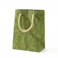 Green gift bag with embossed vintage floral patterns and cream braided rope handles - Medium