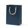 Minimalist deep blue gift bag with golden rope handle and premium matte texture - Medium