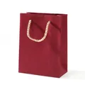 Elegant deep red matte gift bag with golden braided rope handles for lipstick and perfume - Medium