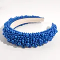 Padded blue velvet headband featuring various sizes of glossy royal blue pearls - Navy Blue