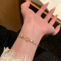 Elegant 18K gold plated bracelet featuring butterfly and flower charms with zircon - Cat's Eye Butterfly Flower Bracelet Gold