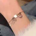 Silver charm bracelet with pink heart, pearl star, and bow pendant on wrist - Sweet Cool Pink Heart Bowknot Bangle