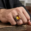 Men's vintage stainless steel ring with a large rectangular amber gemstone and carvings - US 7 / Vintage Silver Tone (Yellow Rhinestone)