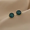 Detailed close-up of retro emerald green stud earrings with twisted gold borders - Gold-Rimmed Green Textured Retro Round Studs (E2755-5) / Peacock Green