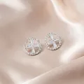 Elegant silver round earrings featuring micro-pave crystals and a central cross design - Round Hollow Cross Rhinestone Studs (E287-1) / Silver