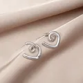 Elegant heart-shaped silver earrings with spiral texture on champagne silk background - Heart Spiral Texture Silver Earrings (E4986) / Silver
