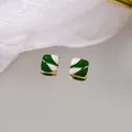 Square green and white enamel stud earrings with gold trim on a mirror surface - Green & White Geometric Patchwork Enamel Style Square Stud Earrings (E4085) / Green and White