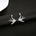 Elegant silver swallow dangle earrings with hollow-out design on black background - Shiny Silver Polished Metal Hollow Swallow Drop Earrings (E3167-2) / Bright Silver