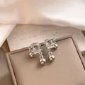 Elegant rectangle zircon stud earrings with silver beads on a brown jewelry gift box - Silver Rectangular Rhinestone Wrapped Bead Drop Earrings (E3048-10) / Silver