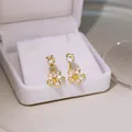 Elegant gold flower earrings with crystals and pearl studs on a white jewelry box display - Gold Double Layer Five-Petal Flower Rhinestone Earrings (E4575-4) / Gold