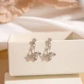 Silver windmill earrings with sparkling zircon centers on a luxury jewelry box display - Silver Windmill Shape Rhinestone Stud Earrings (E2714-2) / Silver