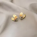 Elegant gold heart earrings with amber and grey crystals on a soft satin background - Heart-shaped Colored Artificial Crystal Stud Earrings (E2054) / Gold
