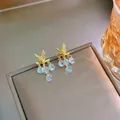 Golden butterfly drop earrings with shimmering multi-faceted crystal charms on a display box - Butterfly Zircon Tassel Earrings (E271-5) / Gold