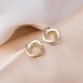 Elegant gold-tone circular stud earrings with pavé rhinestones on silk fabric - Intertwined Round Micro-paved Rhinestone Stud Earrings (E3022) / Gold