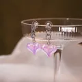 Elegant silver chain earrings with iridescent purple heart pendants on a glass rim - Purple Iridescent Heart Pendant Chain Earrings (E2739) / Silver