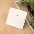 Cream white small faux leather jewelry pouch with gold snap button on a wooden surface - PU Leather Snap Bag / 8*8cm / Off White