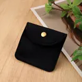 Black velvet jewelry pouch with golden snap button on a light wood grain surface - Lis Velvet Snap Bag / 8*8cm / Black
