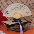 Vintage Chinese folding fan featuring blue floral embroidery and a matching blue tassel - Embroidery Fan - Blue Butterfly