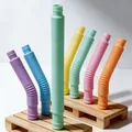 Macro detail of colorful flexible pop tubes showing retractable corrugated plastic texture - 19mmx140mm / Macaron Green