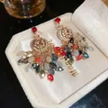 Detailed macro view of colorful crystal tassel earrings resting in a white velvet box - Silver Needle Inlaid Diamond Flower Tassel Stud Earrings (2#)