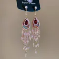 Close-up detail of vintage ethnic crystal tassel earrings with red gemstone centerpiece - Streaming Flower Tassel (28# 925 Sterling Silver Earring Post) / Pink