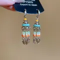 Detailed view of ethnic style tassel earrings with colorful beads and sparkly crystals - 30# Silver Post - Multicolor
