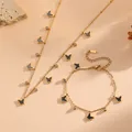 Dettaglio set gioielli in oro con ciondoli a farfalla in smalto nero e catena acciaio - Set Collana Bracciale (D309-M307) / Oro / Conchiglia Nera