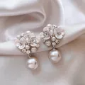Macro detail of elegant floral zircon earrings with large white pearl drops on silk background - Silver Earring Post Style / White