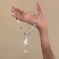 Detailed close-up view of a blue starfish and white conch shell beaded necklace for summer. - Starfish Conch Beaded Style (HN12165) / Necklace - White - Blue