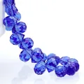 Macro view of teardrop deep blue faceted crystal glass beads with precise light reflection - Medium Blue & White / 8mm (Approx 87 beads/strand)