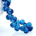 Macro shot of faceted dark blue teardrop crystal glass beads with light reflection - Peacock Blue / 6mm (approximately 87 Beads Per Strip)