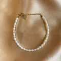 Macro detail of Baroque freshwater pearl bracelet with gold heart charm on silk fabric - Bracelet Style D bp3-3.5 (17+3cm)
