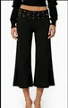 Detail of high waist black wide leg shorts featuring gold rivet studs and decorative trim - S / Black Rivet