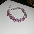 Elegant close-up of a silver-toned flower bracelet featuring magenta and white crystals. - Five-Petal Flower / Silver with Pink Stone