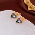 Boucles d'oreilles cœur élégantes avec émail violet, perles et détails de nœud dorés. - Tige en Argent - Boucles d'Oreilles Coeur en Émail Violet