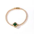 Close-up of gold-plated tennis bracelet with green four-leaf clover motif and clear zircons - Gold Green Zirconia